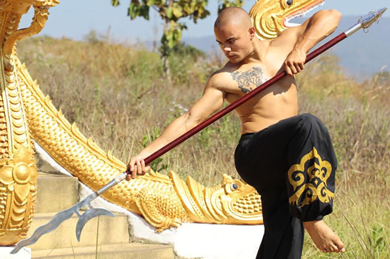 Steve in a cat stance holding a spear