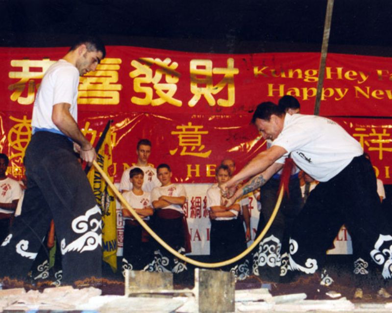 Master Iain Armstrong bending a wooden spear against the soft portion of his throat using Iron Shirt Qigong.