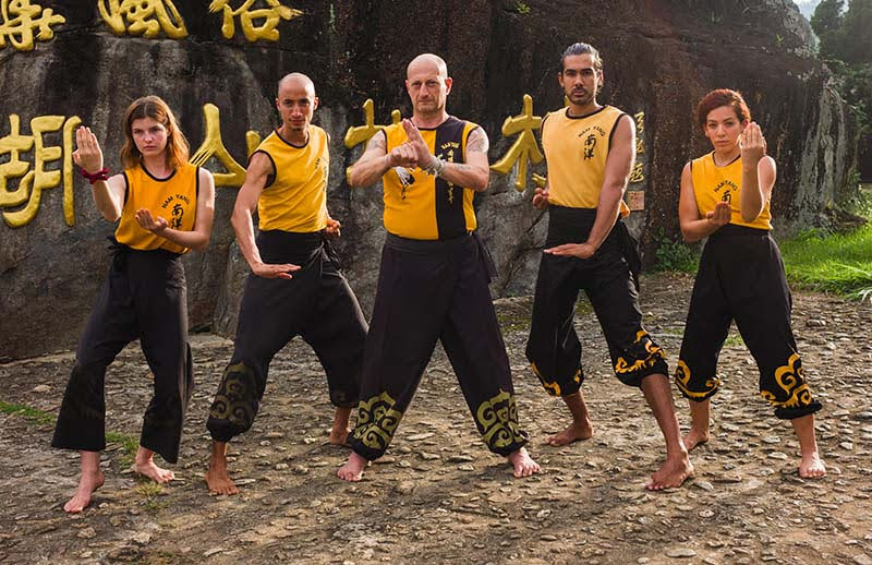 Nam Yang Instructors Posed in Kung Fu Strikes, Stances, and Saluts