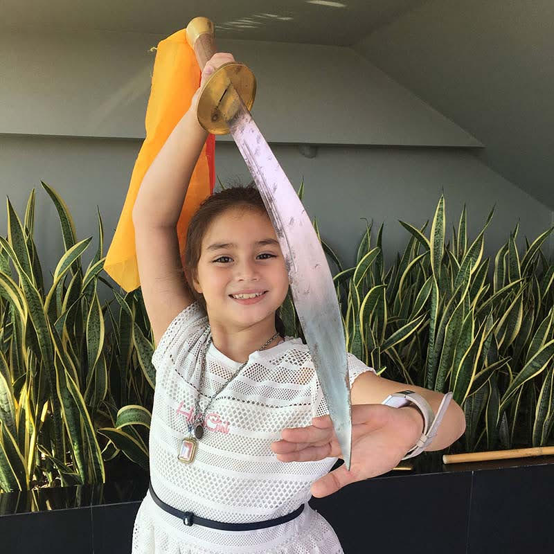 Freya Armstrong holding a chinese broad sword