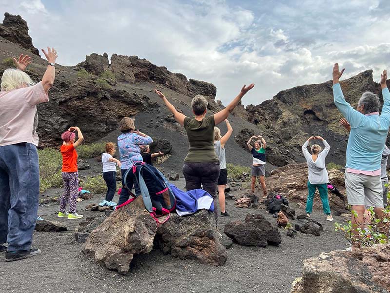 Lauras class practicing qigong in a volcanic crater
