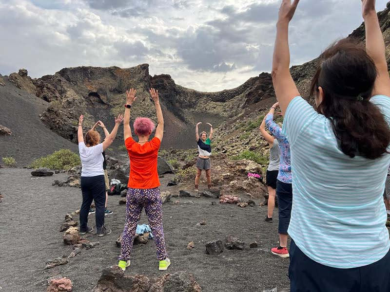 Lauras class practicing qigong in a volcanic crater