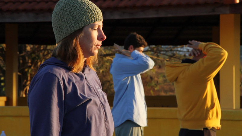 Students practicing Qigong as the sun rises