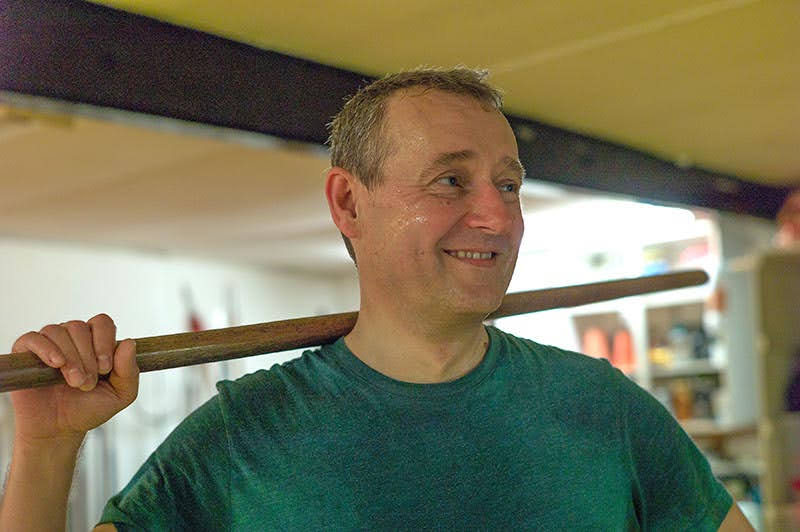 Portrait shot of Simon holding a Shaolin Staff